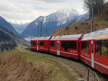 Train on snowcapped mountains against sky