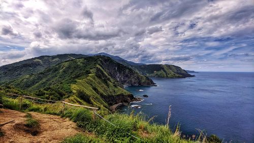 Scenic view of sea and mountains against sky