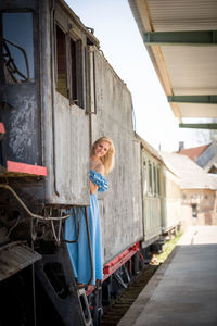 Happy young woman in old train