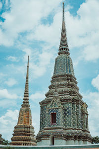 Low angle view of temple building against cloudy sky