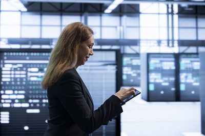 Portrait of young businesswoman using mobile phone