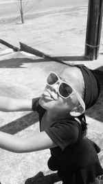 Portrait of boy wearing sunglasses at beach