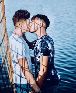 Side view of couple kissing in water