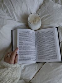 Midsection of woman reading book