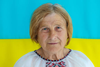 Senior woman against ukrainian flag