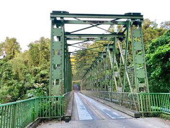 View of bridge over road against trees