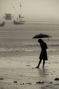 Silhouette of woman standing on beach