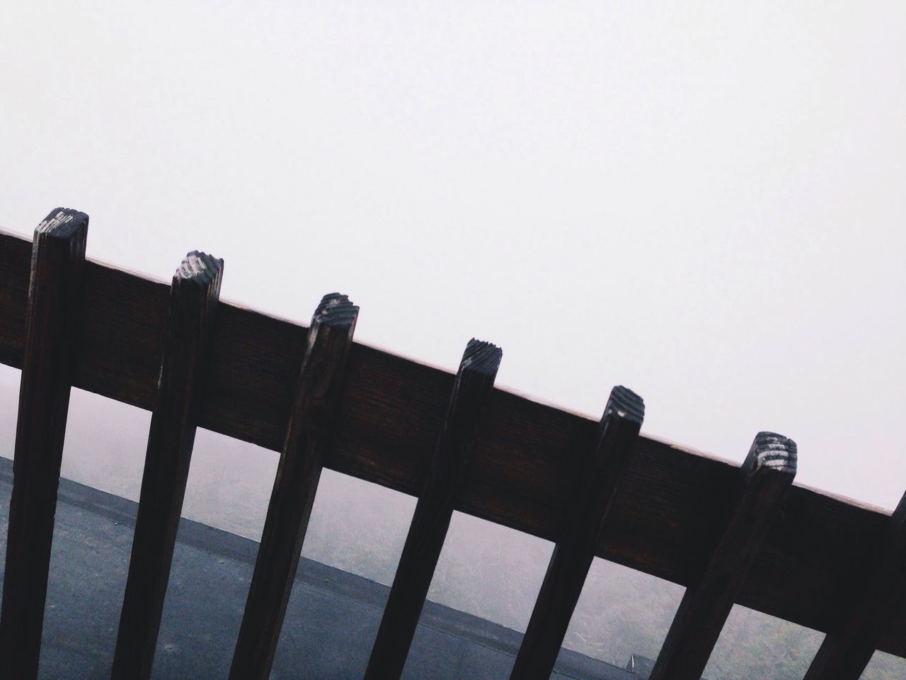 clear sky, copy space, low angle view, architecture, built structure, in a row, building exterior, side by side, sky, day, no people, outdoors, repetition, high section, roof, wood - material, pattern, metal, architectural column, overcast