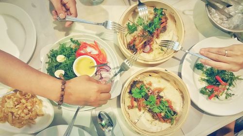 Cropped image of hand holding food