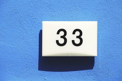 Close-up of number 33 on blue wall