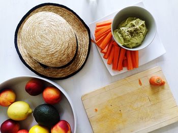 High angle view of hat and carrots on table in kitchen