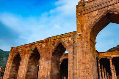 Ancient grand mosque called adhai din ka jhonpra vintage architecture with bright blue sky at day