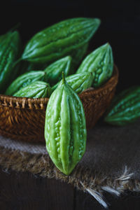 Close-up of green chili peppers against black background