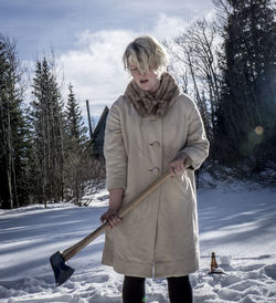 Full length of woman standing on tree trunk