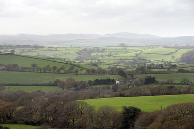 Scenic view of field against cloudy sky