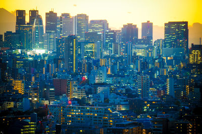 High angle view of illuminated city buildings against sky