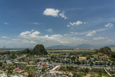 High angle view of cityscape against cloudy sky