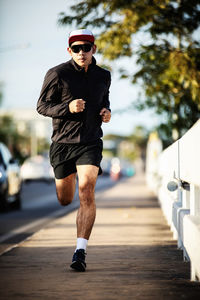 Full length of man wearing sunglasses on footpath