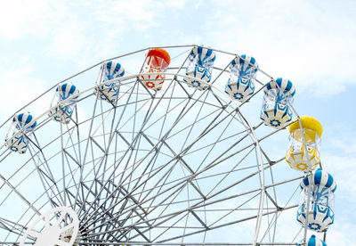 Low angle view of ferris wheel against sky