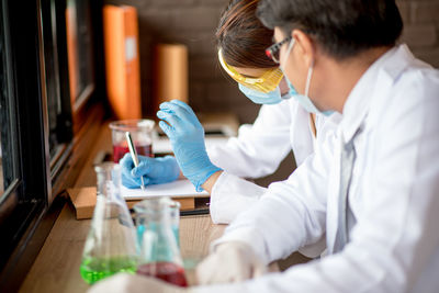 Man and woman performing experiment in laboratory