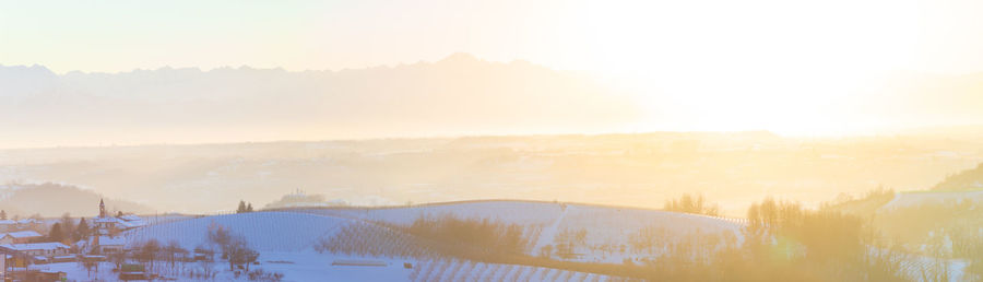 Scenic view of snowcapped mountains against sky during sunset