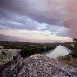 Scenic view of land against sky during sunset