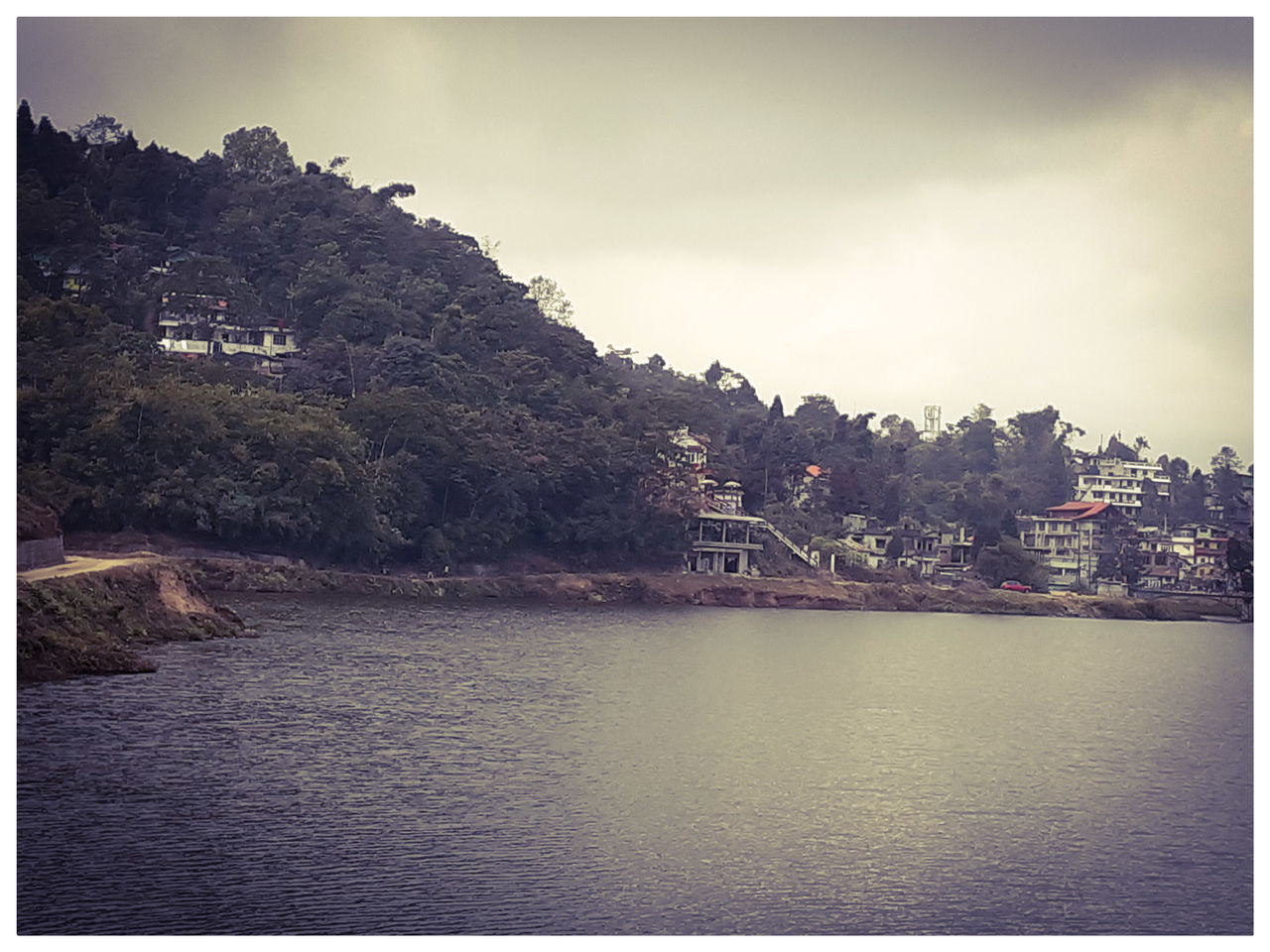 RIVER AND TOWNSCAPE AGAINST SKY