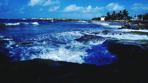 Scenic view of sea against cloudy sky