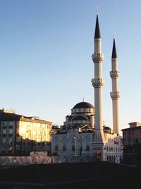 View of buildings in city against clear sky