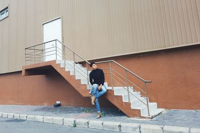Full length of man standing by steps