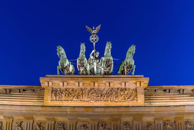 Statue against blue sky