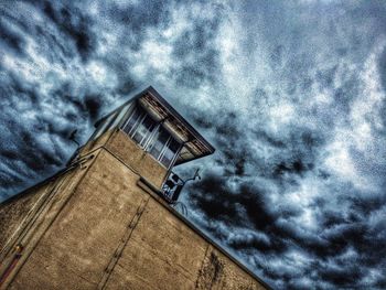 Low angle view of building against cloudy sky