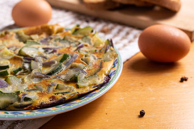 Zucchini and red onion omelette. high angle view of omelette on table