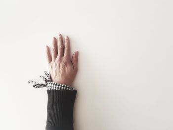 Close-up of woman hand against white background