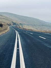 Empty road against sky