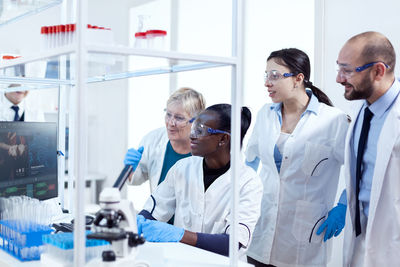 Female doctor examining chemical in laboratory