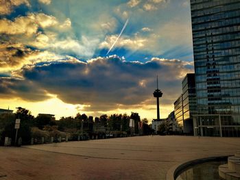 Panoramic view of buildings against cloudy sky