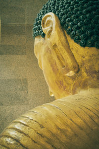 Close-up of buddha statue against building