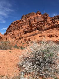 Low angle view of rocky mountains against sky