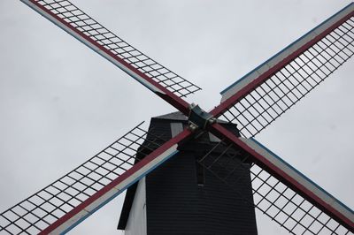 Low angle view of traditional windmill against sky