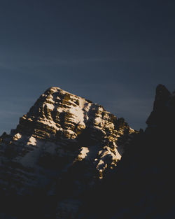 Low angle view of rock formation against sky