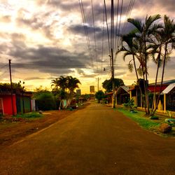 Road against cloudy sky at sunset