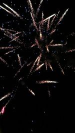 Low angle view of firework display at night