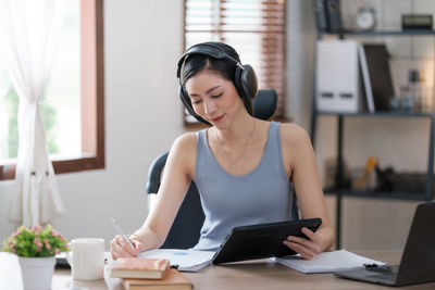 Young woman using laptop at home