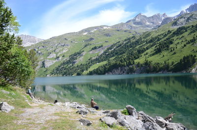 Scenic view of lake and mountains against sky