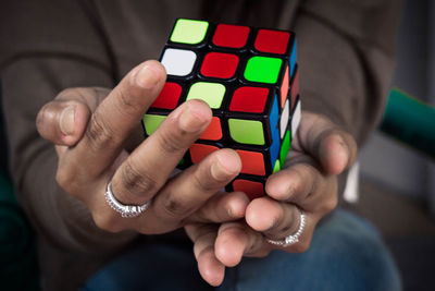 Midsection of woman holding puzzle cube