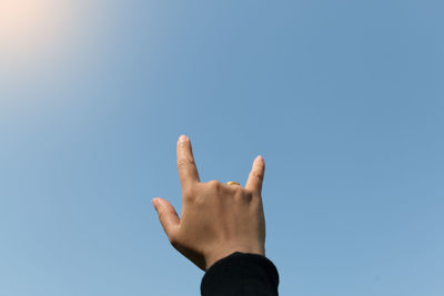 Midsection of person against clear sky