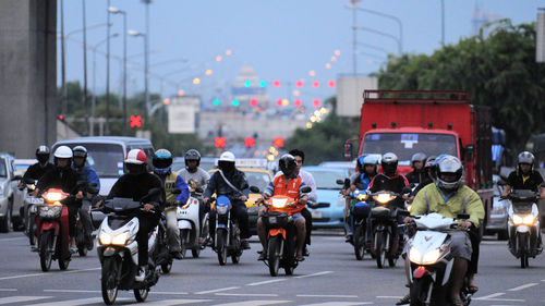 People riding vehicles on street