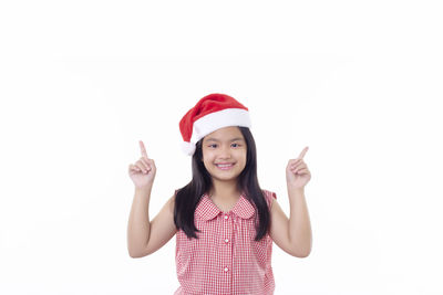 Portrait of a smiling young woman against white background