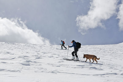 Two women ski up mount sopris with a dog in colorado